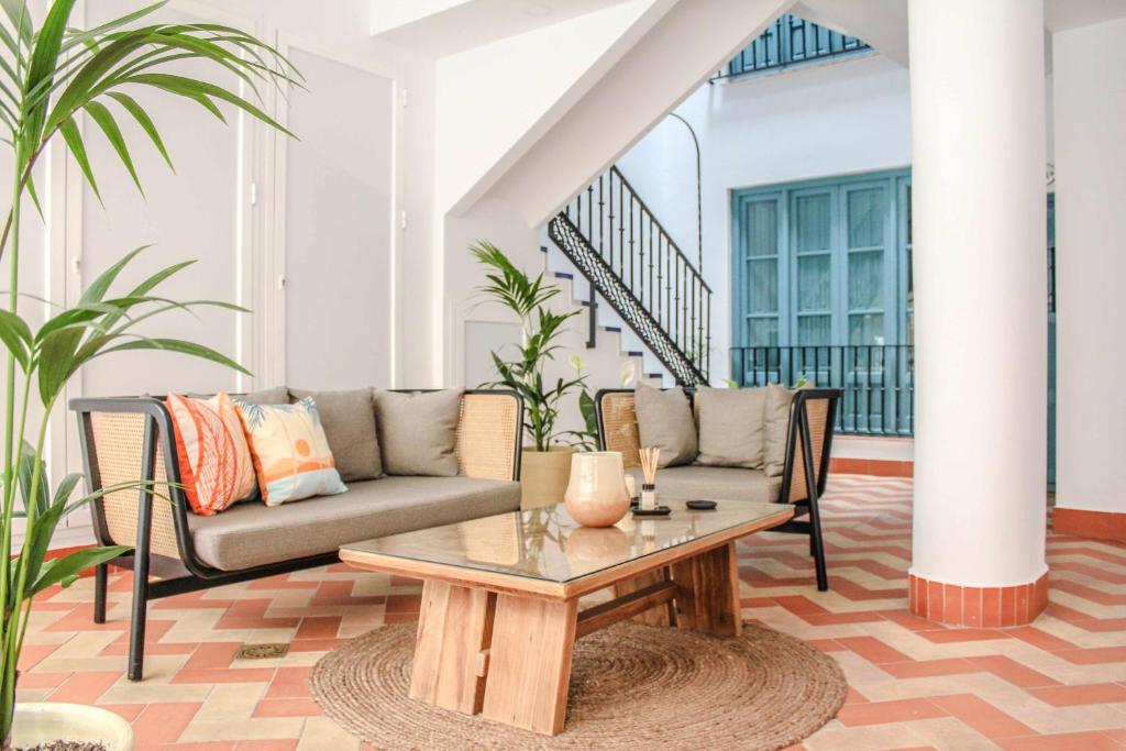 a living room with a couch and a table at MonKeys Apartments Pureza House in Seville