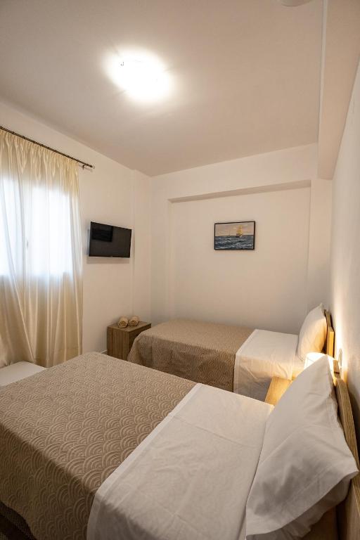 A bed or beds in a room at Filocsenia luxury apartment at tsoutsouras