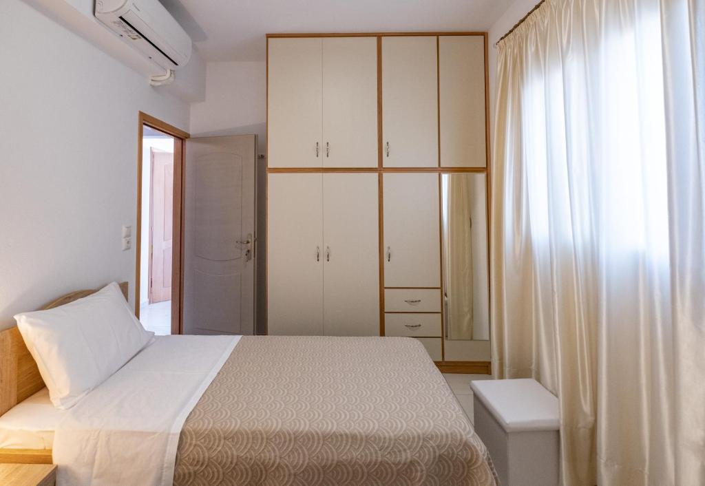 A bed or beds in a room at Filocsenia luxury apartment at tsoutsouras