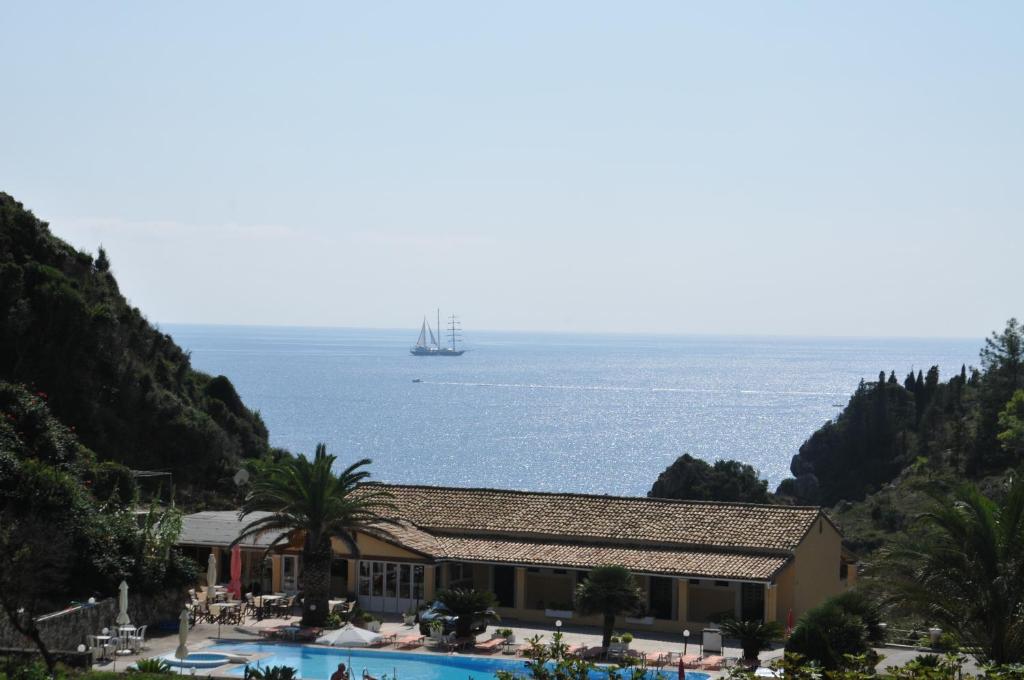 a view of the ocean with a ship in the water at Sea View in Paleokastritsa