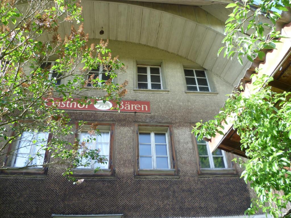 un bâtiment avec un panneau sur son côté dans l'établissement Gasthof Rössli Gondiswil, à Gondiswil