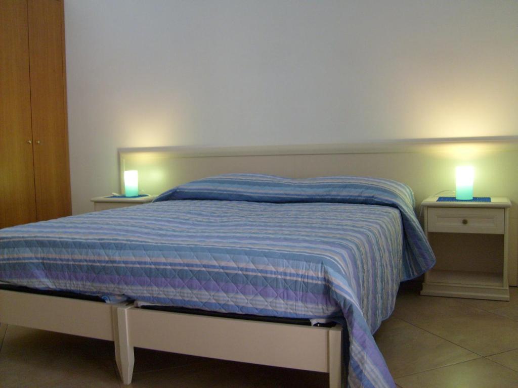 um quarto com uma cama com duas luzes em Casa Vacanze Puccia em Modica