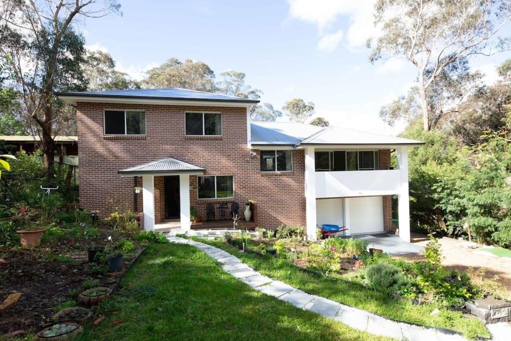 a brick house with a garden in front of it at The roses house - Cozy and Modern house in Katoomba in Katoomba