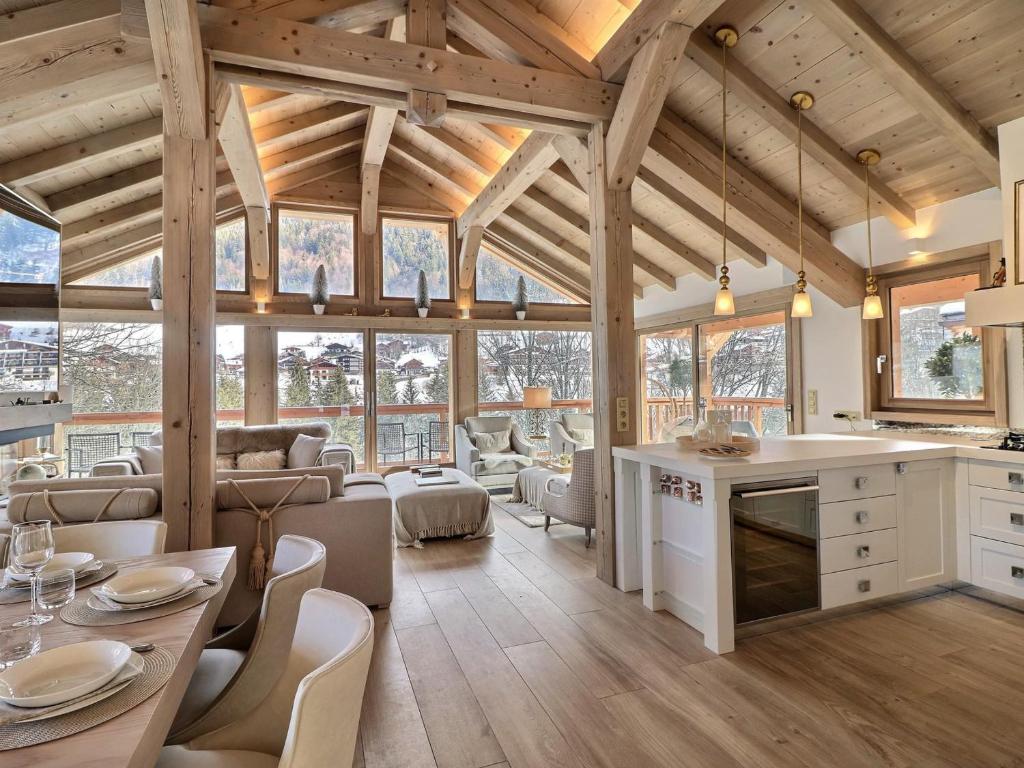 a large kitchen and living room with wooden ceilings at Chalet Morzine, 7 pièces, 12 personnes - FR-1-627-20 in Morzine