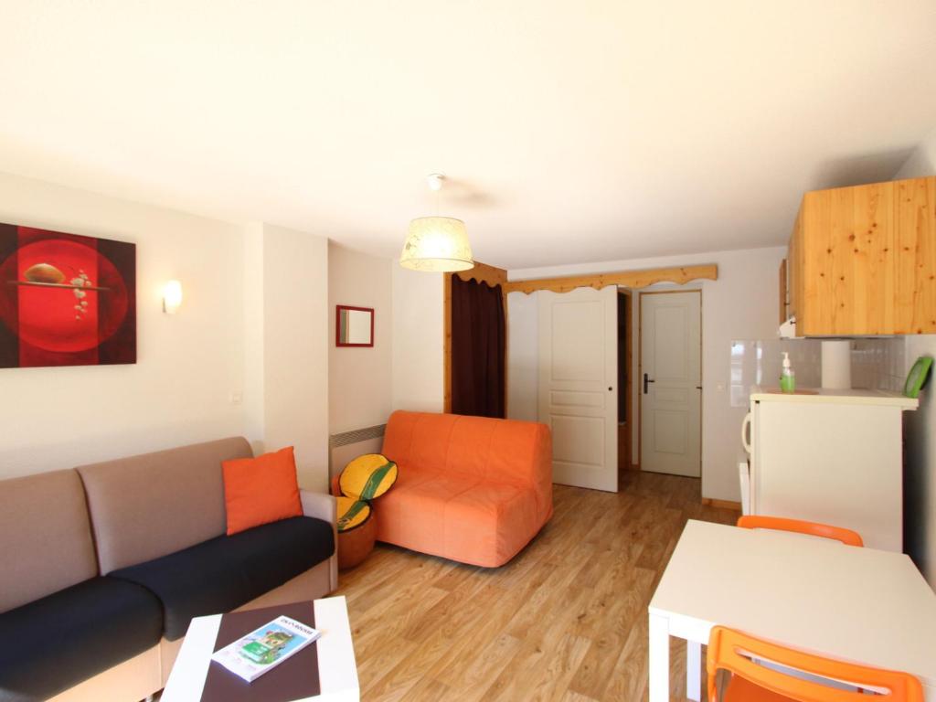 a living room with a couch and a table at Studio Chamrousse, 1 pièce, 4 personnes - FR-1-340-243 in Chamrousse