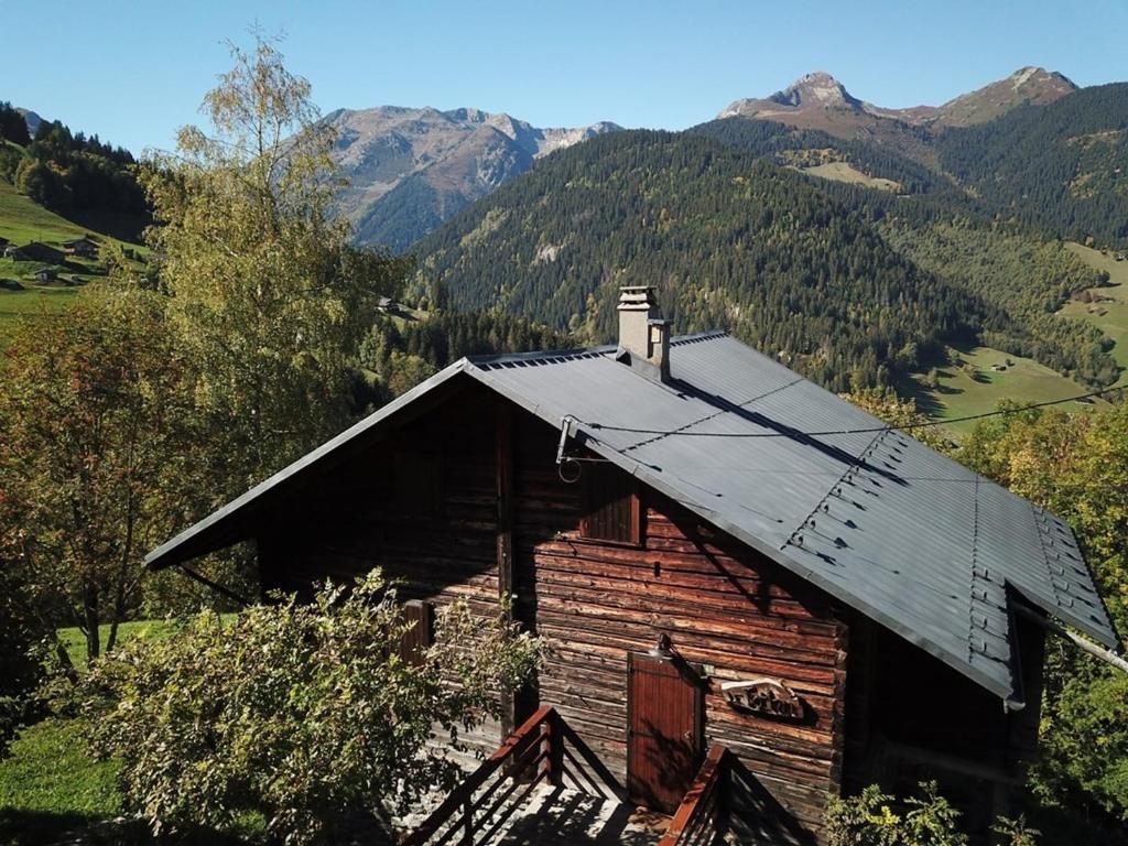an old wooden cabin with mountains in the background at Chalet Arêches-Beaufort, 4 pièces, 10 personnes - FR-1-342-224 in Beaufort