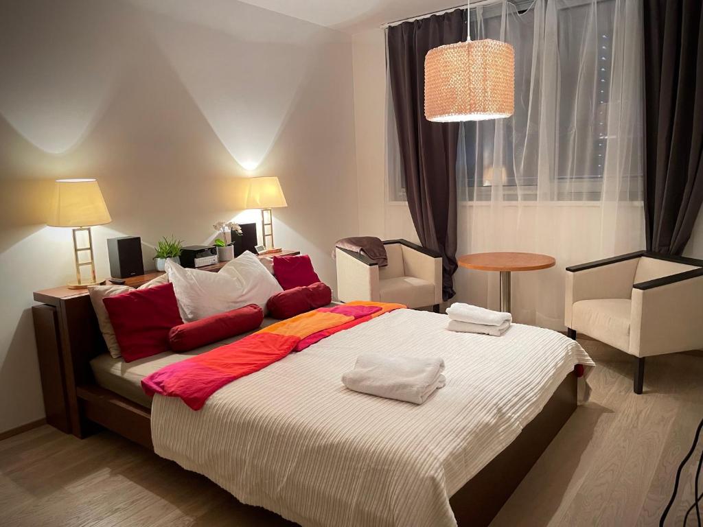 a bedroom with a large bed with two towels on it at Harfa Apartment 30 in Prague