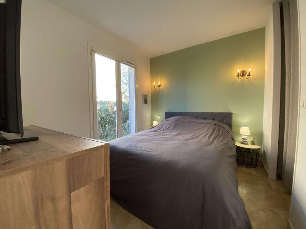 a bedroom with a bed and a large window at Appartement Sainte-Maxime, 3 pièces, 4 personnes - FR-1-226-476 in Sainte-Maxime