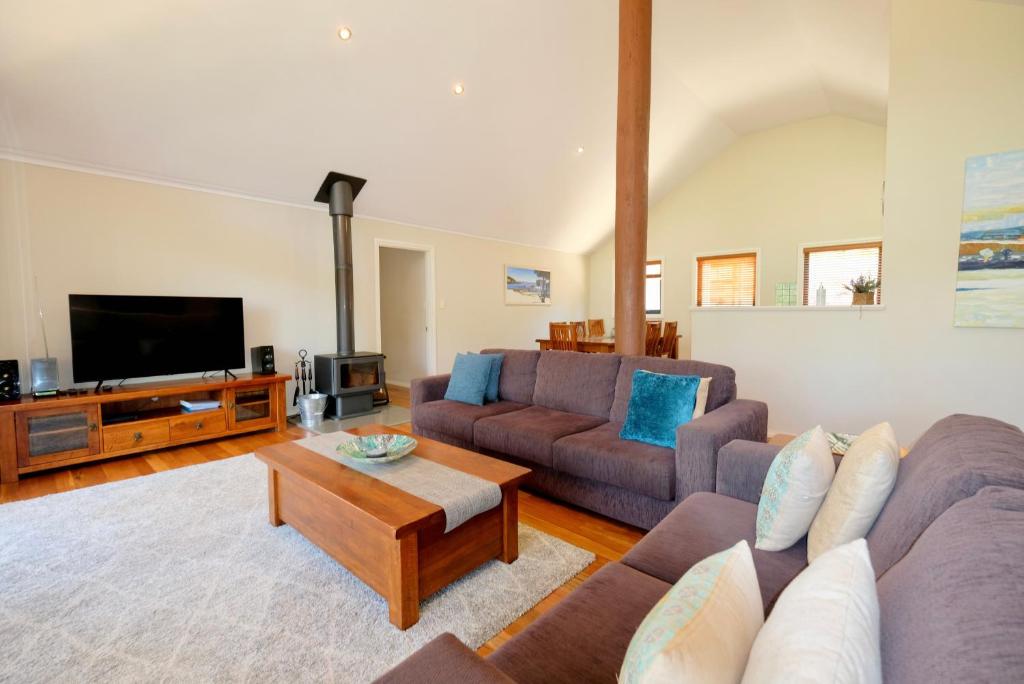 a living room with two couches and a tv at Treehouse-elevated nature setting, kids TV room in Quindalup