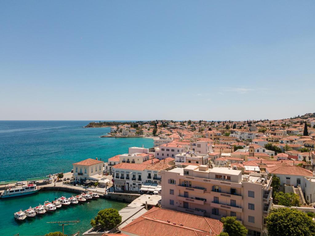 an aerial view of a town with boats in the water at Hotel Roumani in Spetses