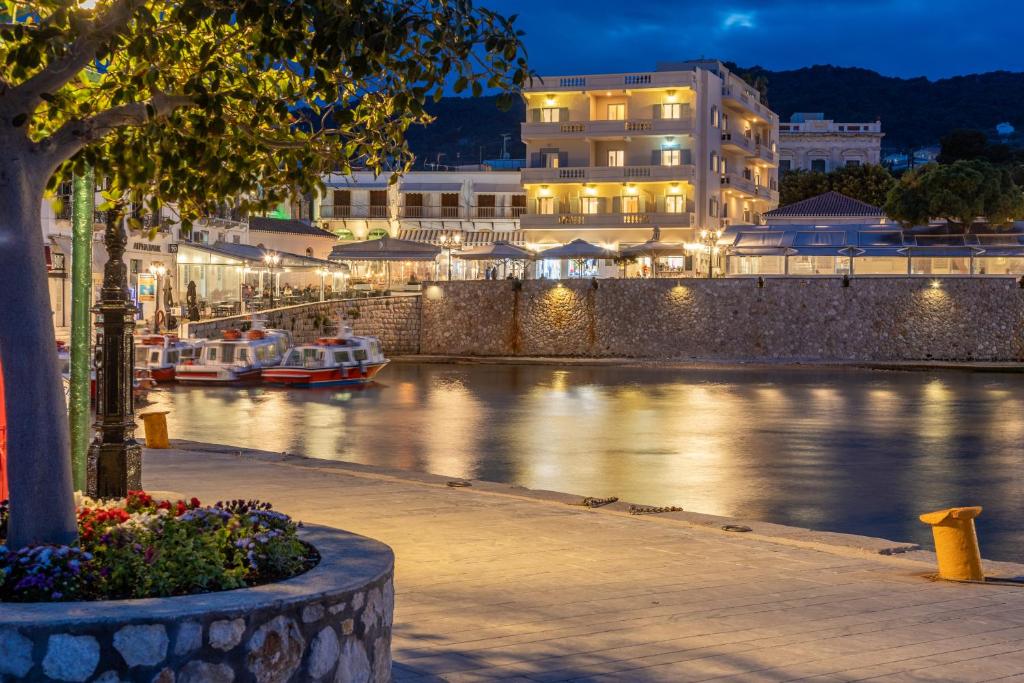 a view of a river at night with boats at Hotel Roumani in Spetses