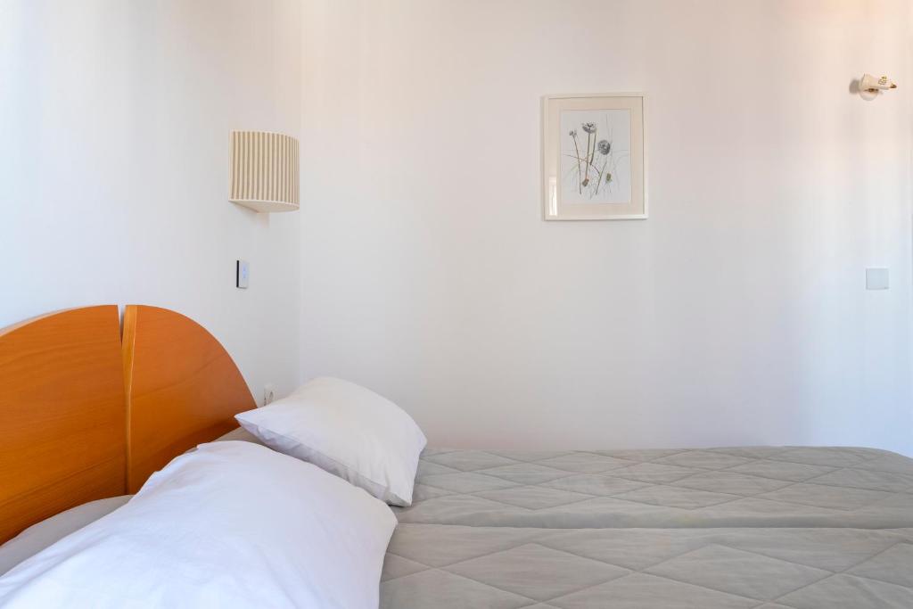 a bedroom with a bed and a picture on the wall at Hotel Roumani in Spetses