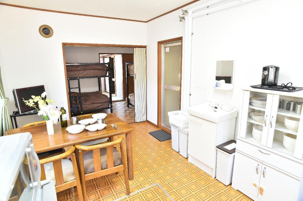 a kitchen with a wooden table and a sink at Greenheim Suitengushita / Vacation STAY 252 in Otaru