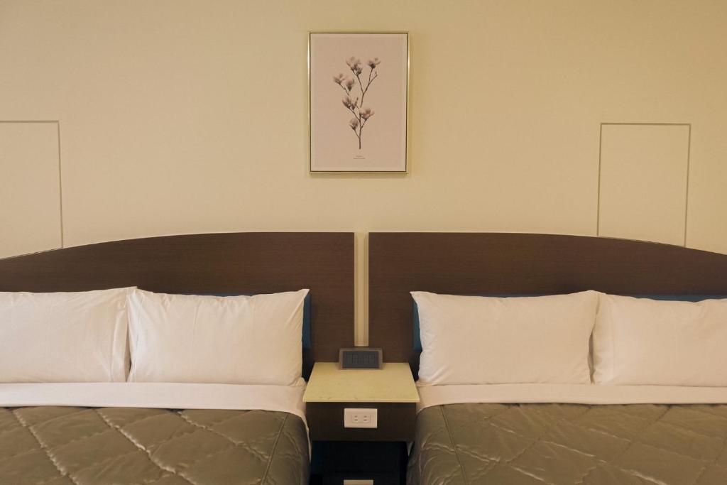 Postel nebo postele na pokoji v ubytování SongHo Hotel
