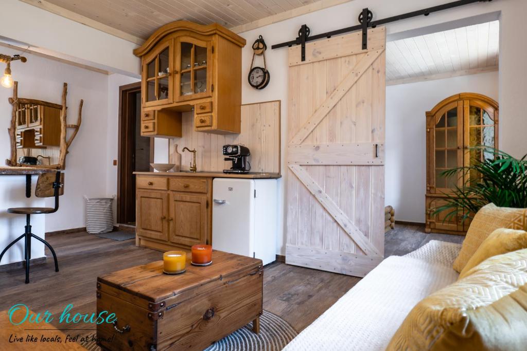 a kitchen with a sliding barn door in a living room at Our House in Sozopol