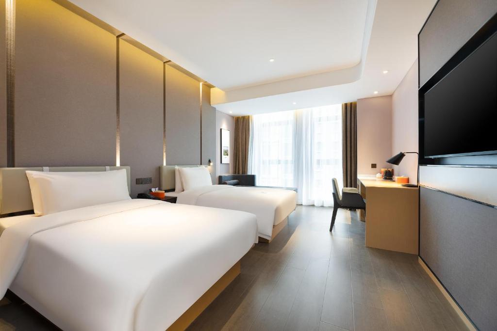 Postel nebo postele na pokoji v ubytování Atour Hotel Xian Software Park High-Tech 3rd Road