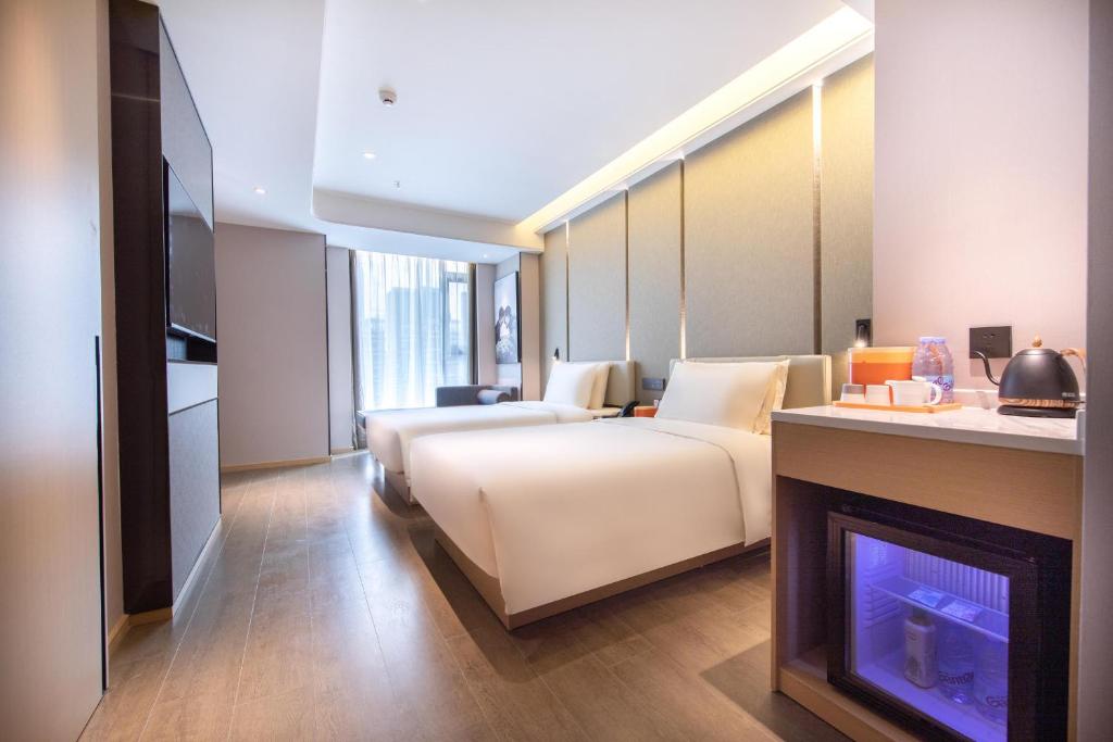 Postel nebo postele na pokoji v ubytování Atour Hotel Zhuhai Gongbei Fuhuali