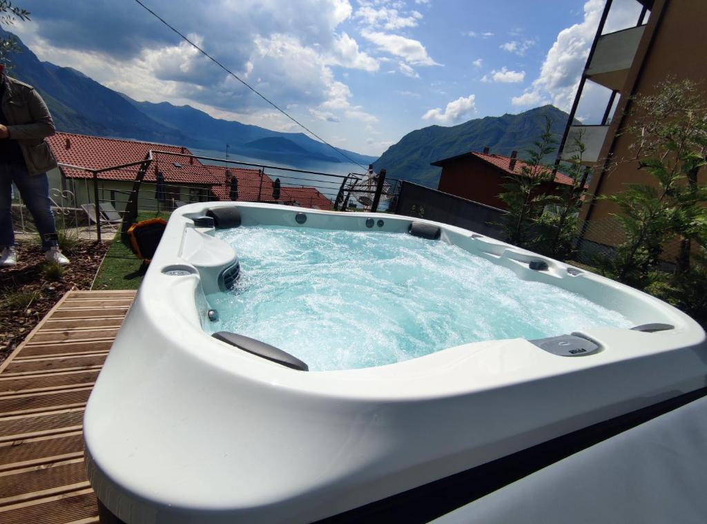 a jacuzzi tub on a deck with a view at Hotel Miranda in Riva di Solto