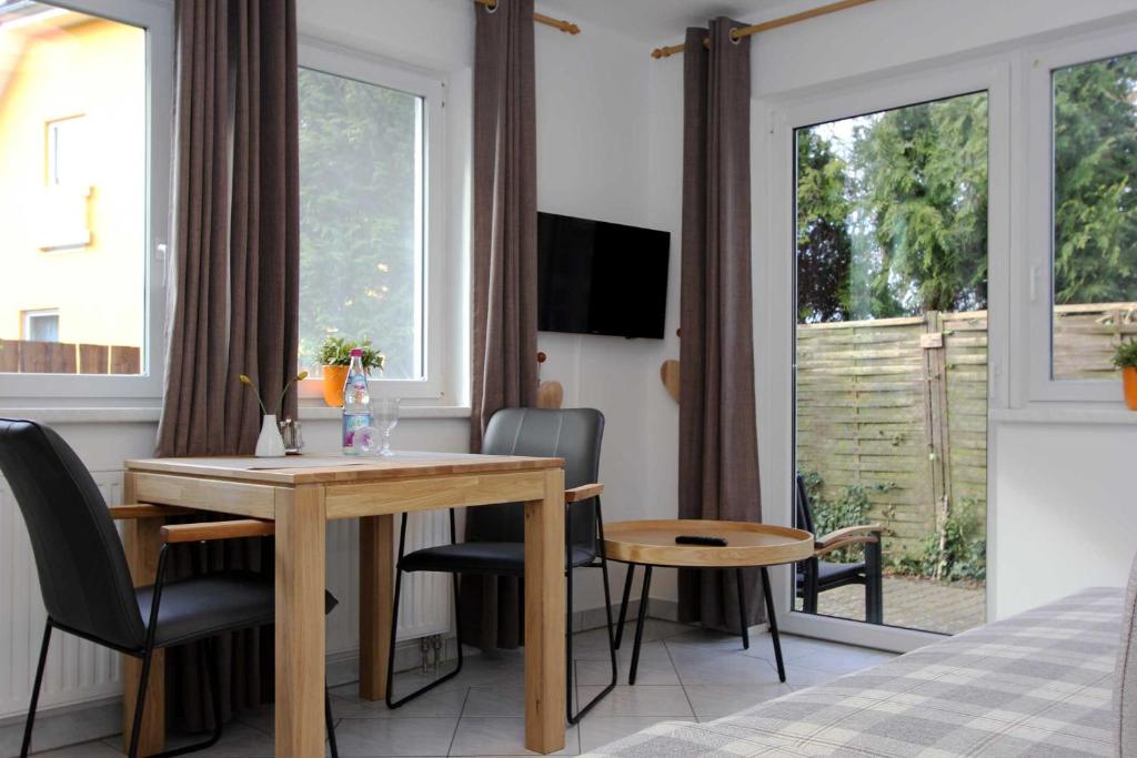 a room with a table and chairs and a bed at Lieblingshaus Eddie in Prerow