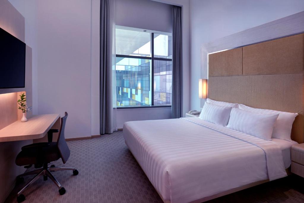 Postel nebo postele na pokoji v ubytování Grand Mercure Jakarta Harmoni