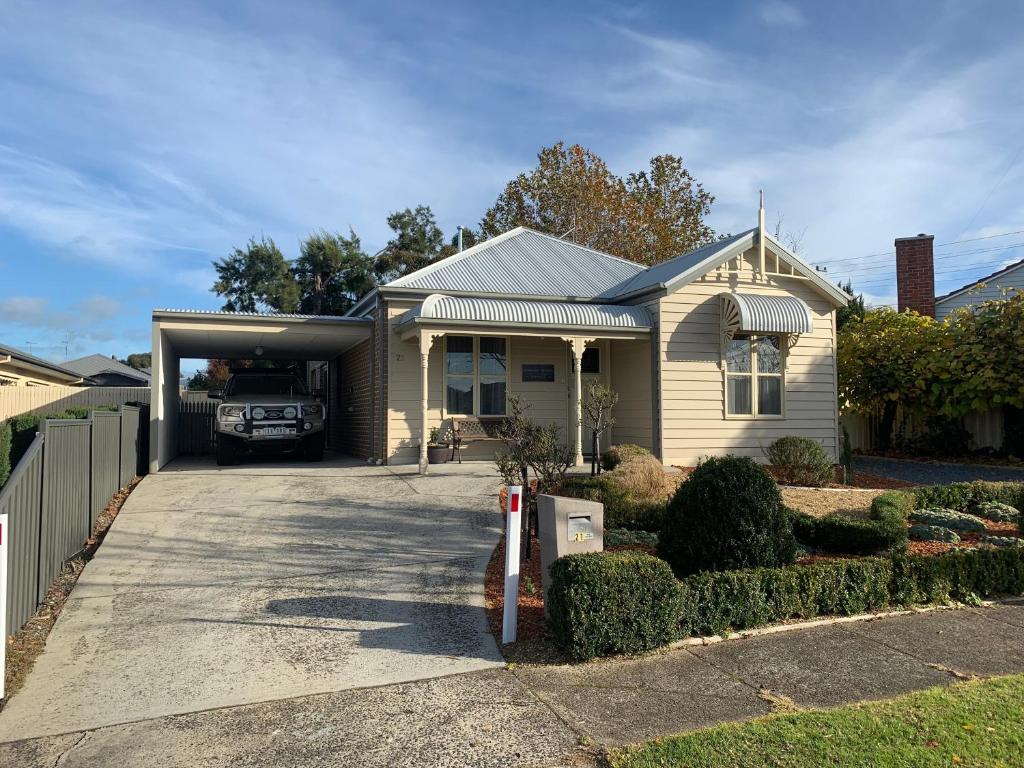 Una casa con un garaje con un camión. en Elmsford Cottage, en Warragul