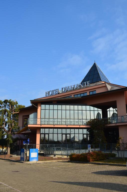 a building with a sign on top of it at Hotel Diamante in Corbetta