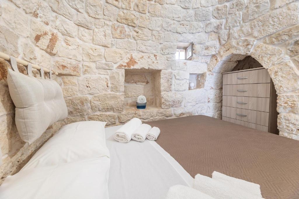 Łóżko lub łóżka w pokoju w obiekcie Trullo Aia Antica