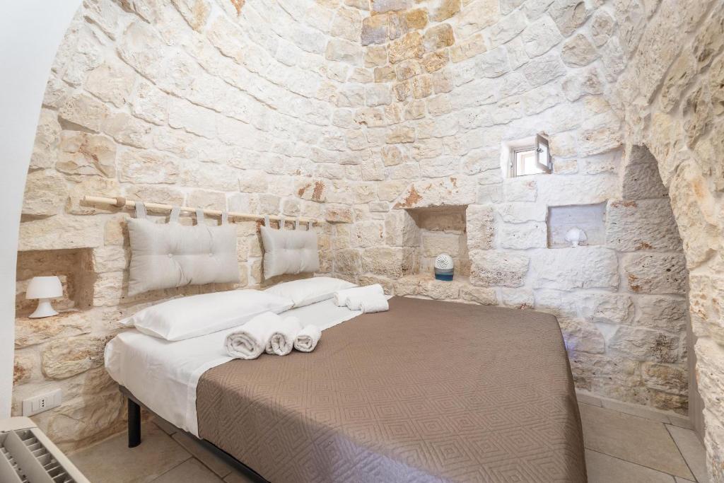 Łóżko lub łóżka w pokoju w obiekcie Trullo Aia Antica