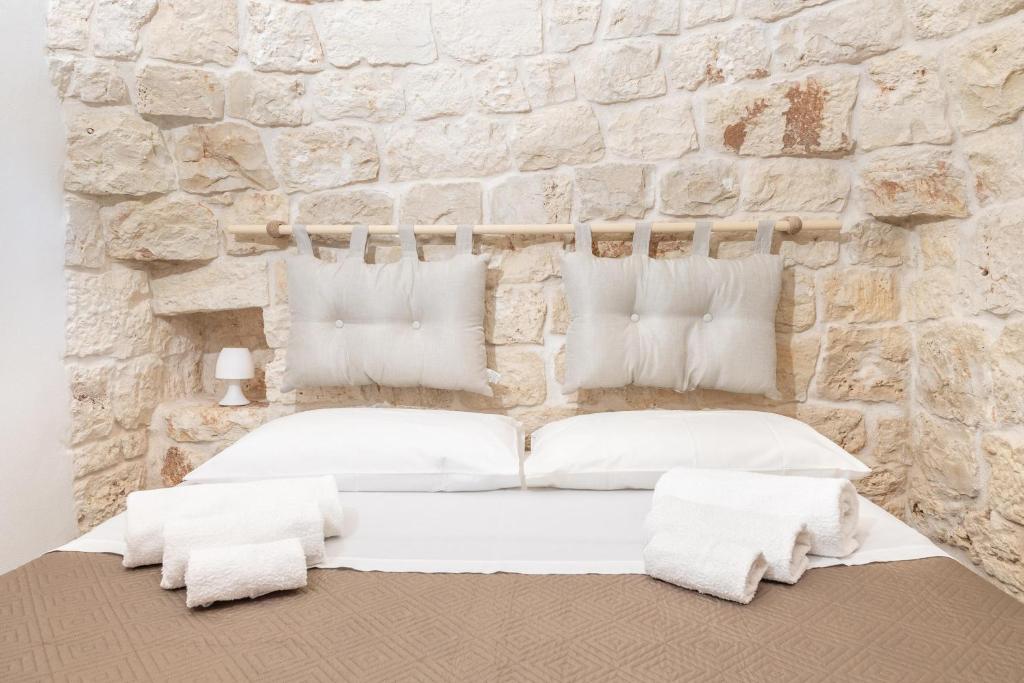 Łóżko lub łóżka w pokoju w obiekcie Trullo Aia Antica