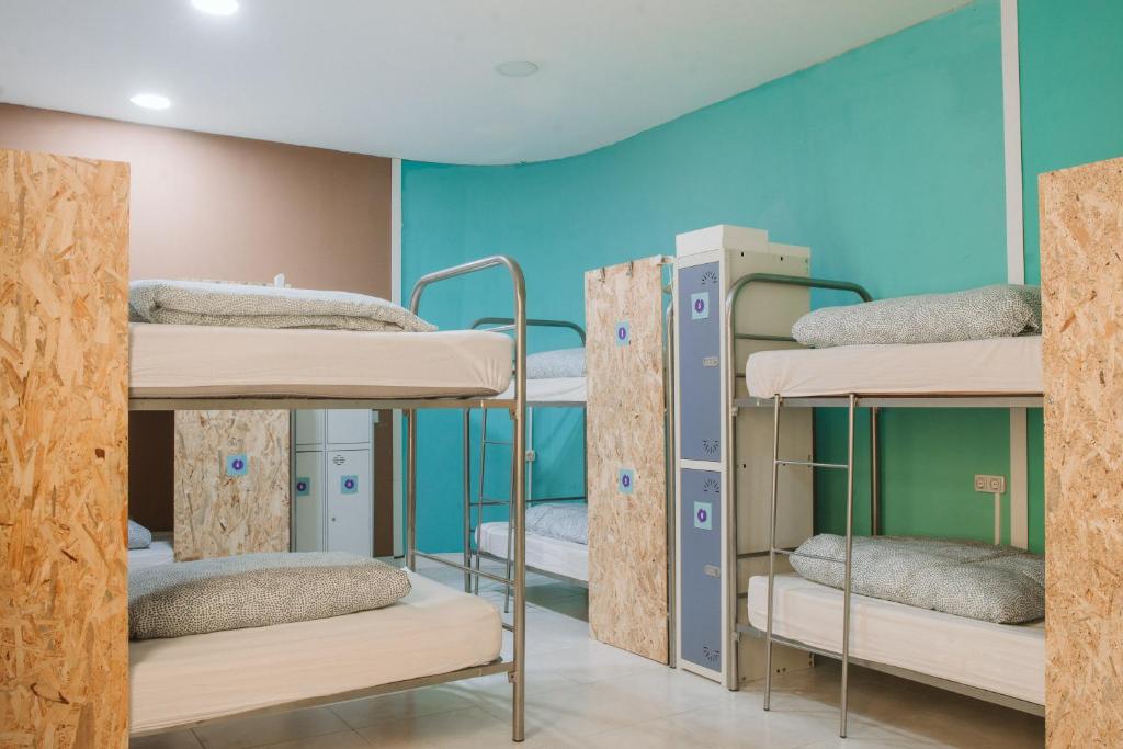 a room with four bunk beds in a hospital at KYO Surf Hostel in Las Palmas de Gran Canaria