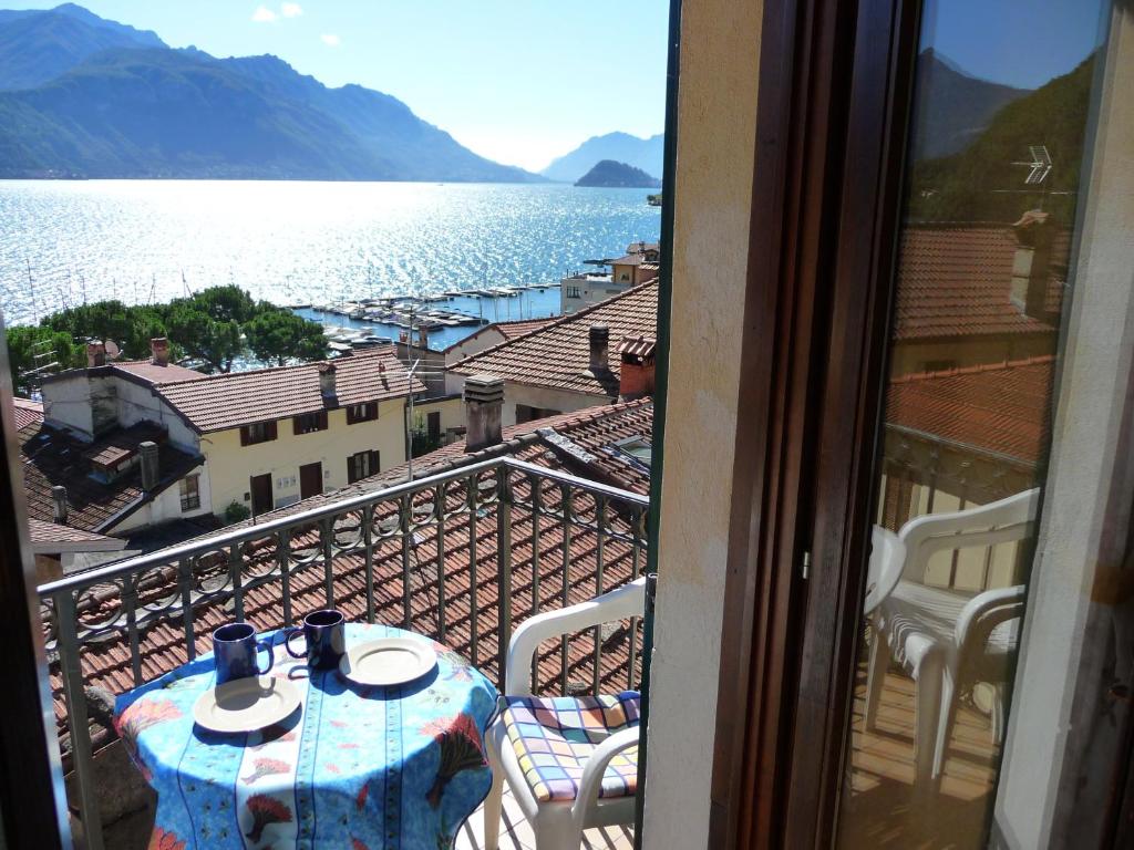 a balcony with a table and a view of the water at Casa Nobiallo in Menaggio