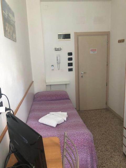 Postel nebo postele na pokoji v ubytování Hotel Zurigo