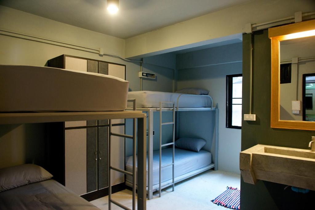 a small room with bunk beds and a sink at 9 Hostel in Chiang Mai
