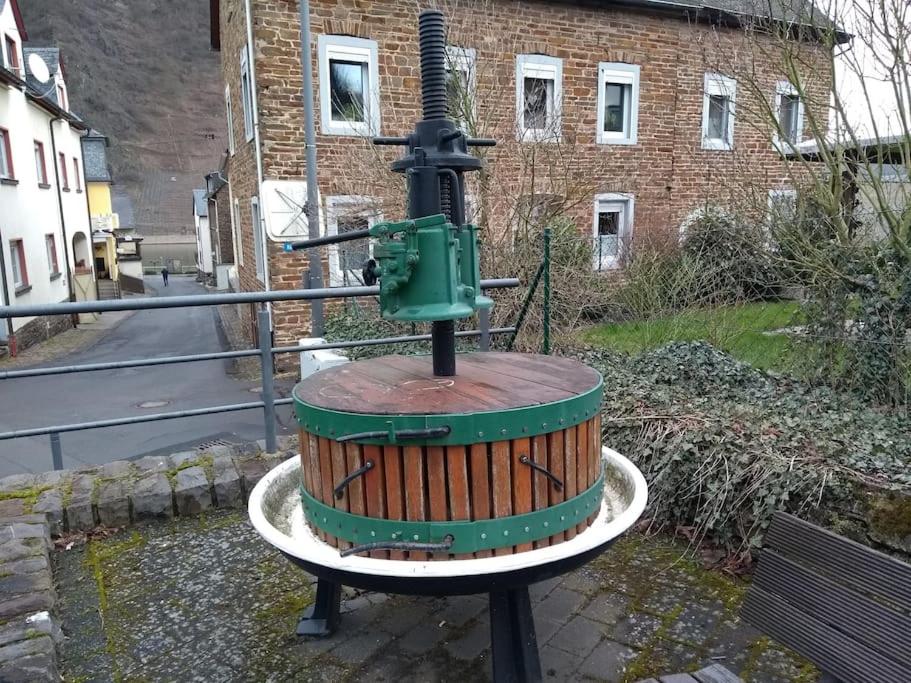 a machine sitting on top of a wooden barrel at luxury holiday home in Cochem for 7 people in Ediger-Eller