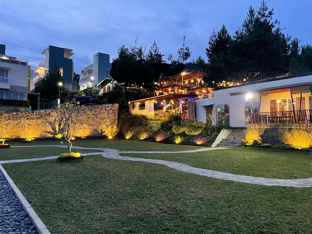 a garden with a tree in the middle of a building at Valle Verde Villas in Bandung