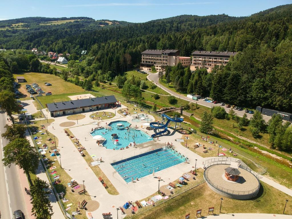 an aerial view of a swimming pool in a resort at Ośrodek Uzdrowiskowy Świerkowy Zdrój Medical Spa in Rymanów-Zdrój