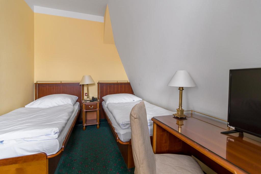 Postel nebo postele na pokoji v ubytování Hotel William