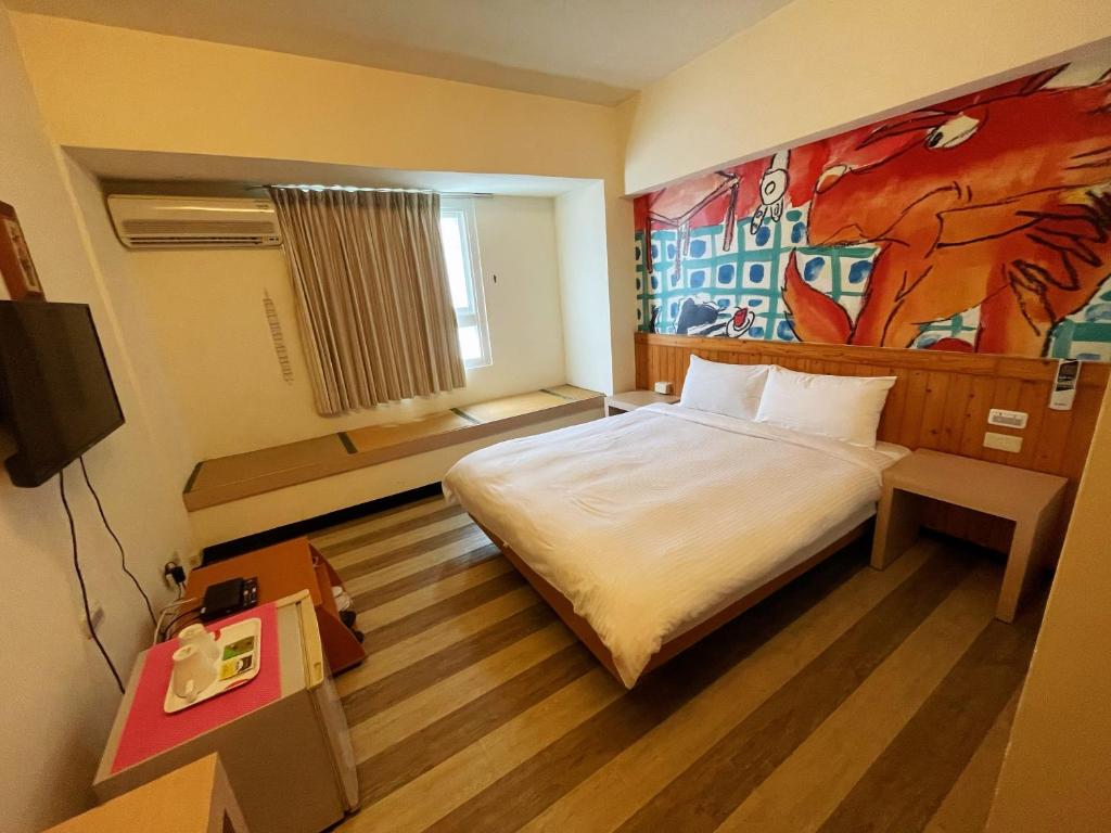 Postel nebo postele na pokoji v ubytování Hwa Hong Hotel