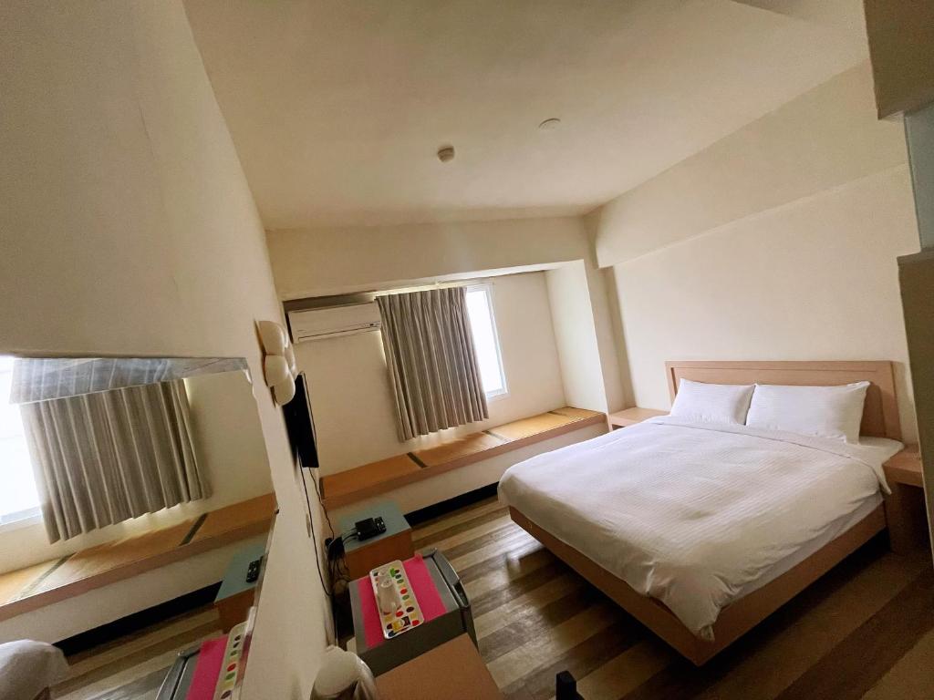 Postel nebo postele na pokoji v ubytování Hwa Hong Hotel