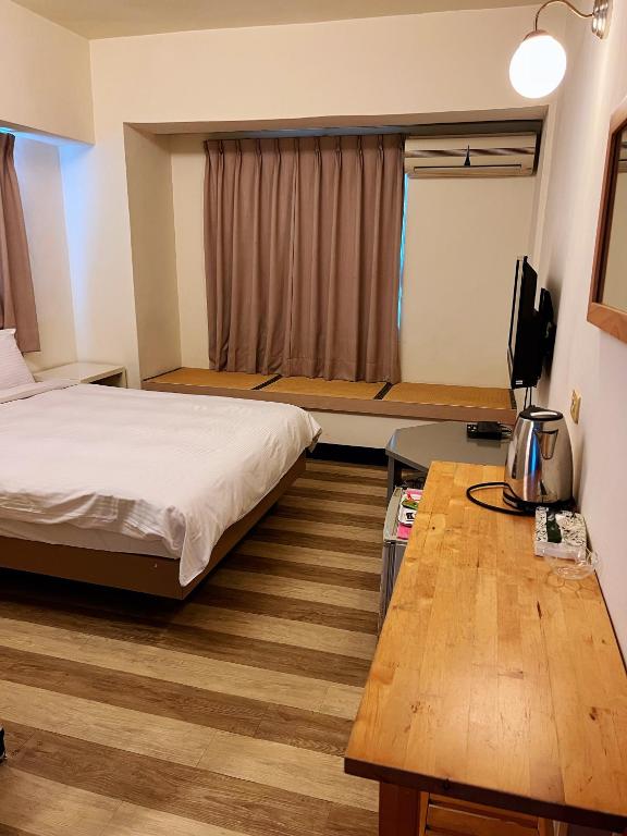 Postel nebo postele na pokoji v ubytování Hwa Hong Hotel