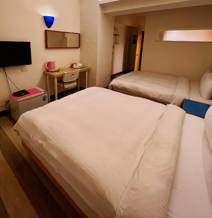 Postel nebo postele na pokoji v ubytování Hwa Hong Hotel