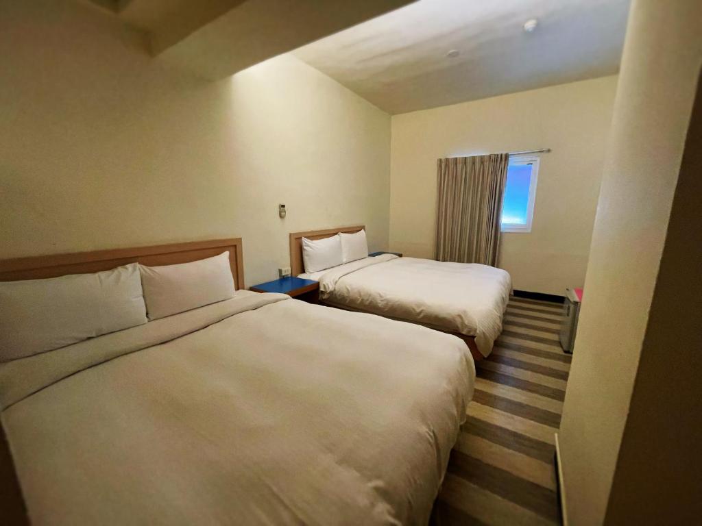 Postel nebo postele na pokoji v ubytování Hwa Hong Hotel