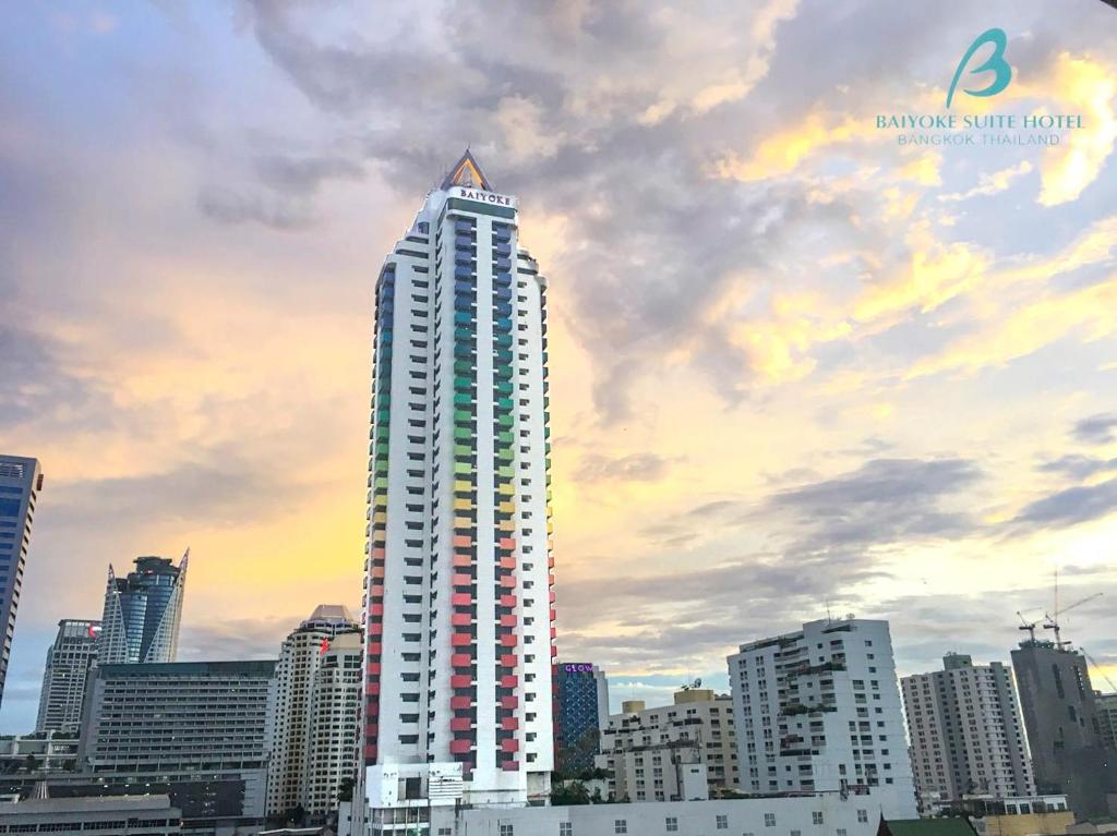 a tall white building with a triangle on top of it at Baiyoke Suite Hotel in Bangkok