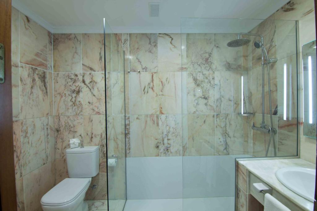 a bathroom with a shower and a toilet and a sink at Hotel Principe Paz in Santa Cruz de Tenerife