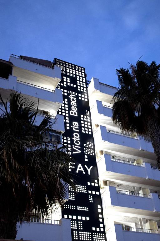 a tall white building with a sign on it at FAY Victoria Beach in Rincón de la Victoria