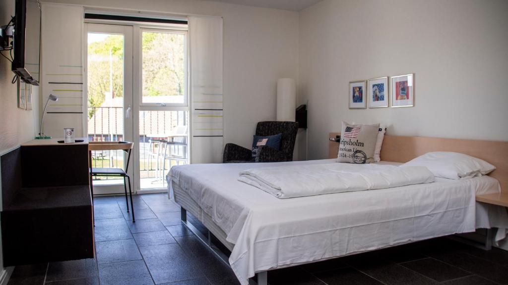 Postel nebo postele na pokoji v ubytování Hotel Strandtangen
