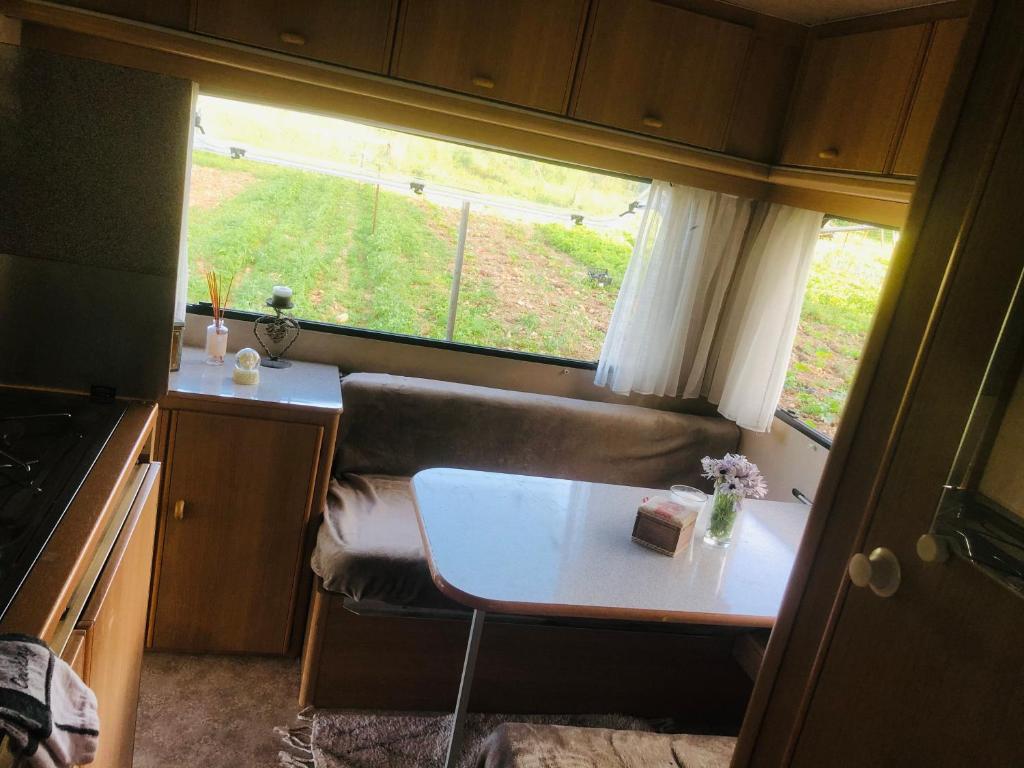 a small kitchen with a table and a window at La Ferme de Rotani in Aléria