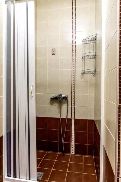a shower with a hose in a bathroom at Canal Luxury Apartments in Nea Potidaea