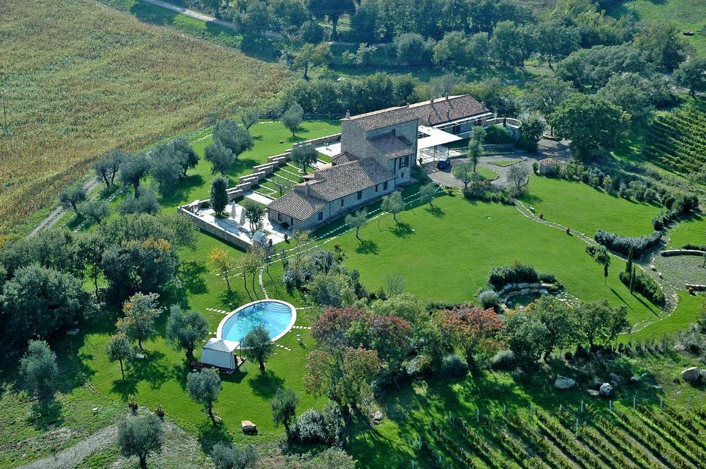 an aerial view of a large house with a swimming pool at Fattoria Pianetti in Manciano