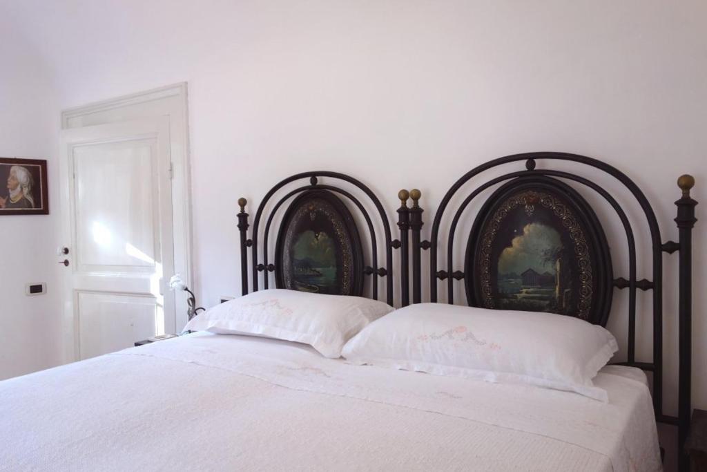 a bedroom with a large bed with white sheets at Antica Dimora Fuori Le Mura B&B in Scanno